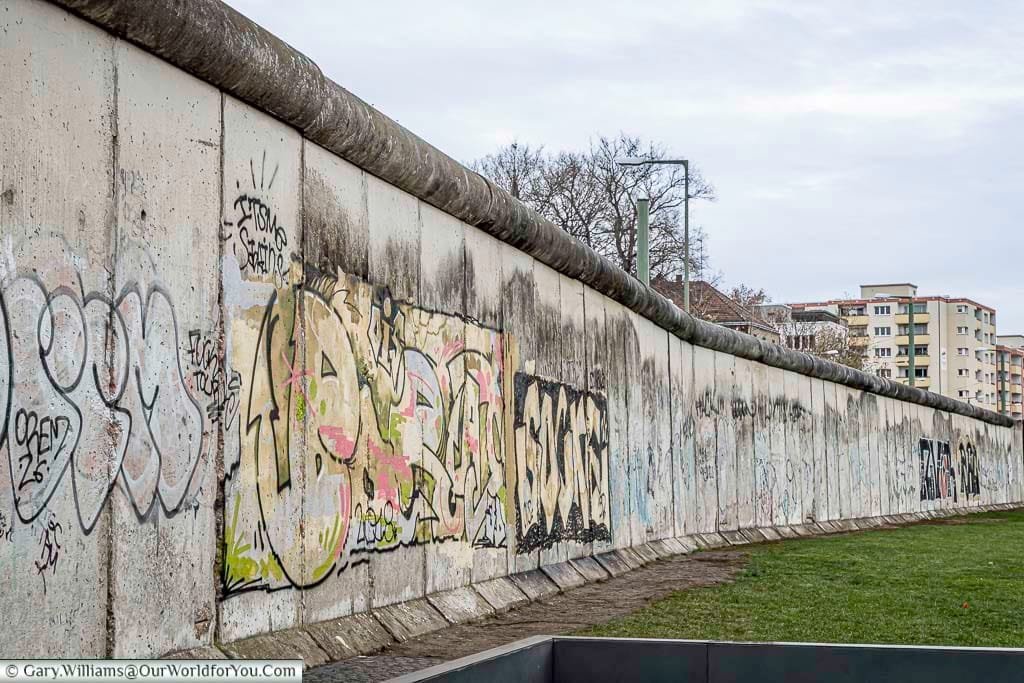 A view as the Berlin Wall as arcs around against Bernauer Strasse with just the tower blocks in the background.