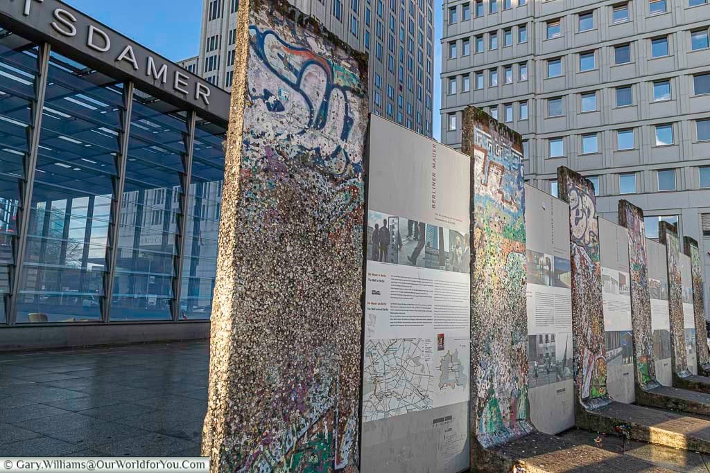 Sections of the Berling Wall, intersected with storyboards, by Potsdamer Platz underground station.