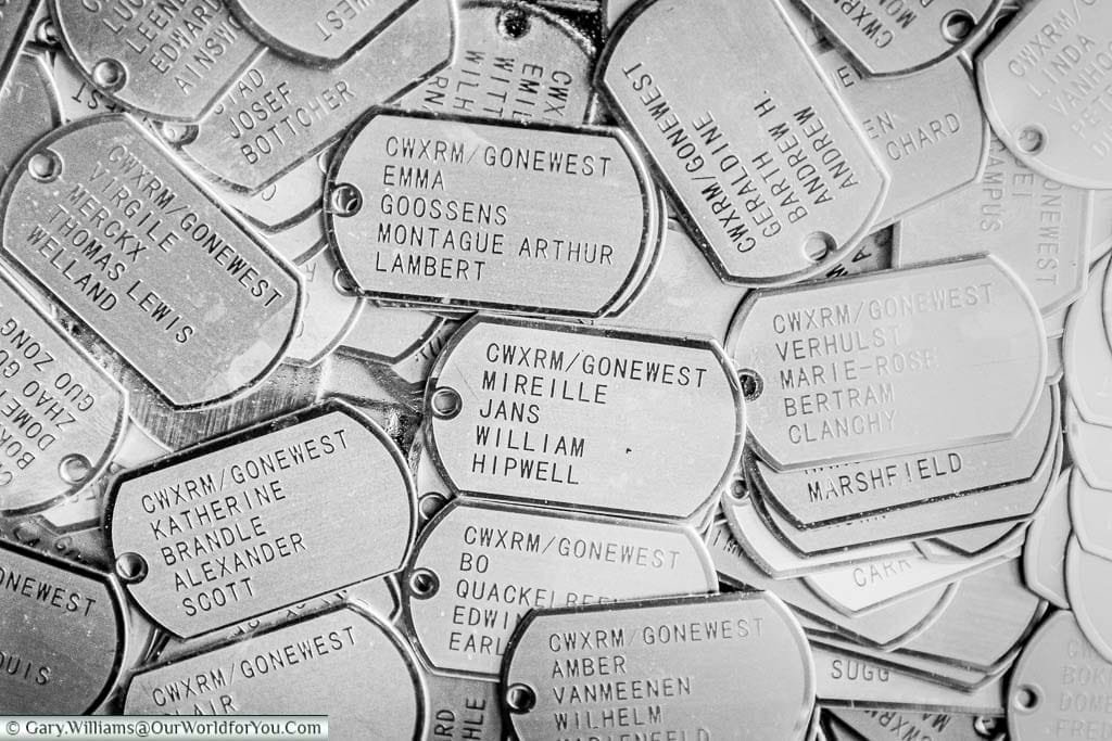 A closeup of a selection of pressed steel dog tags for the CWXRM exhibition in belgium