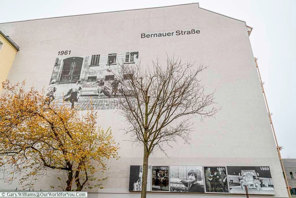A large picture of people fleeing across the street on a building on Bernauer Strasse.
