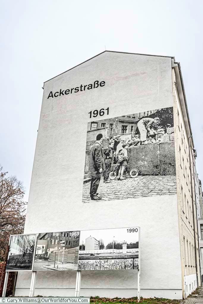 A blown-up picture on the end of a building block depicting the scene of the Berlin Wall in 1961.