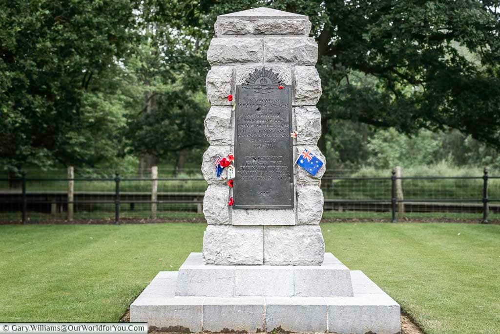 A stone monument featuring a brass plaque riddled with bullets to the australian tunnelling company the battlefields of belgium