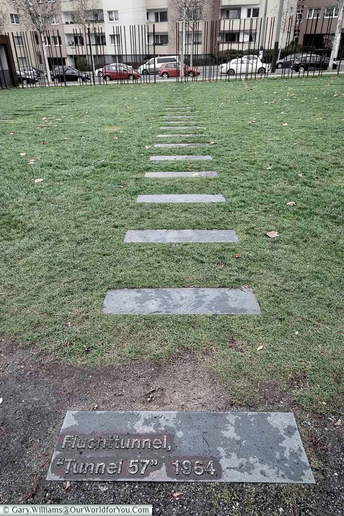 Steel stepping-stones across the grass of no-man's-land marks out the path of "Tunnel 57", another attempt to breach the Berlin Wall.