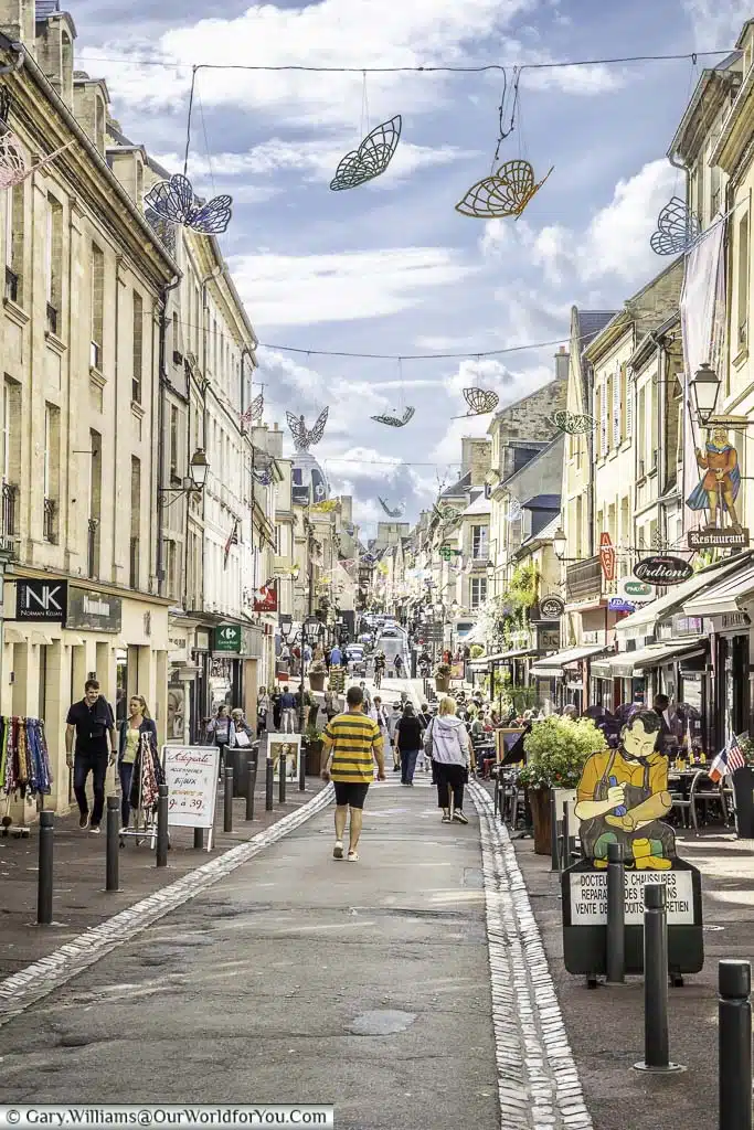 The bustling rue saint jean, the main pedestrianised thoroughfare in bayeux normandy, france