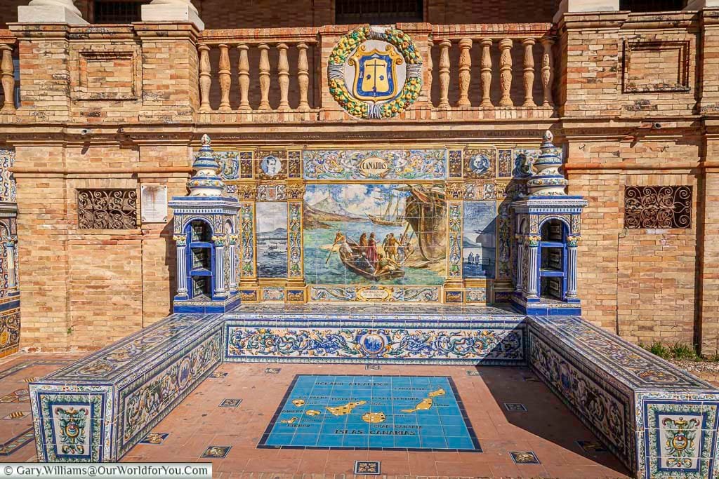One of the features of the Plaza de España in Seville is the tiled alcoves for each of the regions of Spain. This is the one for the Canaries. The primary colours of the tiles are blue & yellow with a scene depicting from the area taking centre spot.