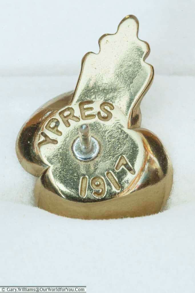 A close-up of the back of our brass royal british legion remembrance passchendaele pins stamped with Ypres 1917