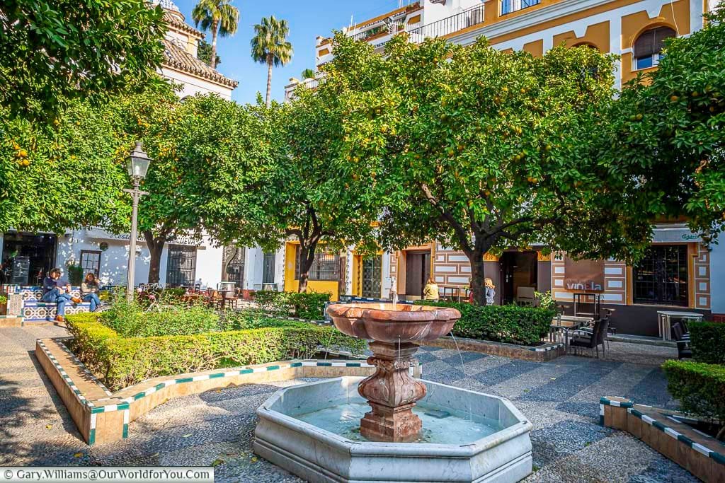 A small red marble fountain in the centre of one of the many small squares you find yourself getting lost in in Seville