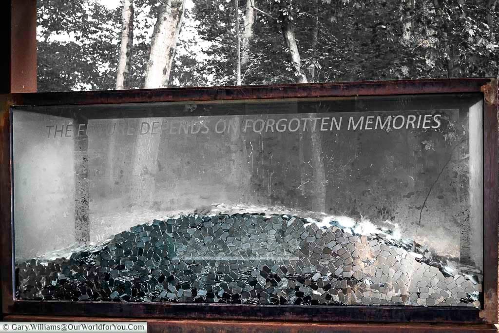 A large glass tanks featuring a selection of pressed steel dog tags for the CWXRM exhibition with the inscription the future depends on forgotten memories