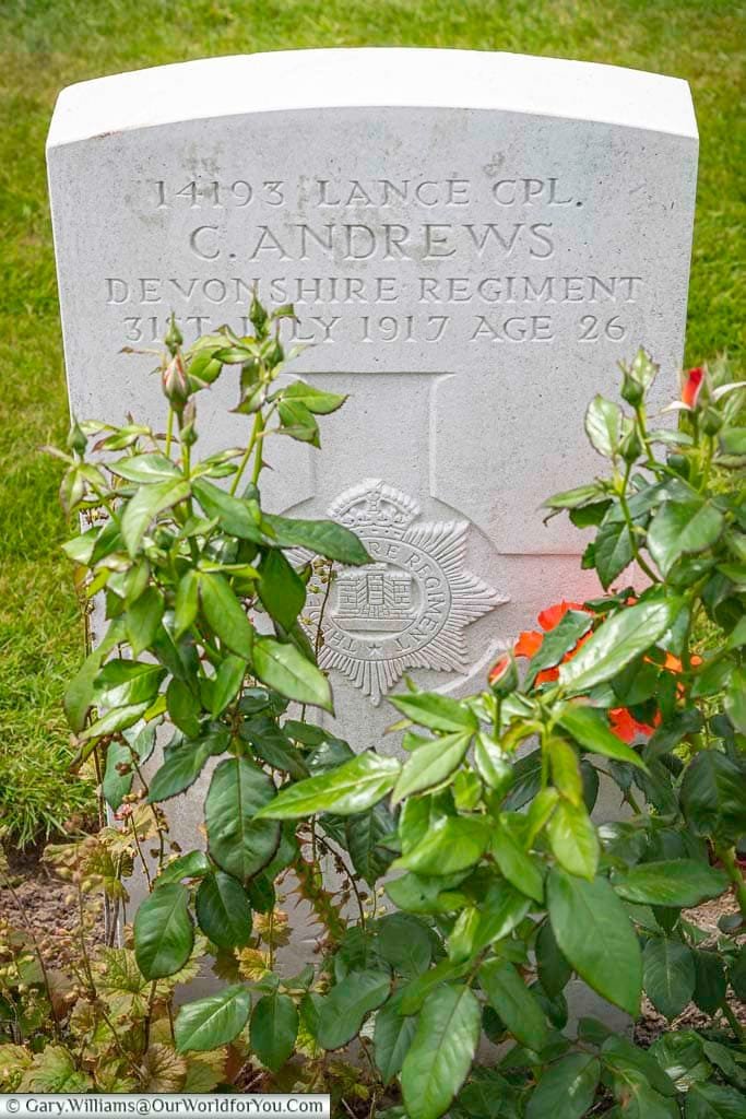 The portland stone commonwealth war graves headstone of Lance Corporal C Andrews at the tyne cot cemetery near passchendaele in belgium
