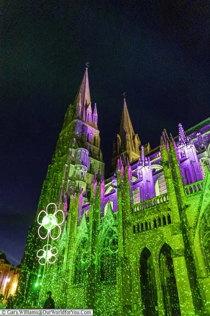 Bayeux Cathedral illuminated at night in green as part of the nightly light display