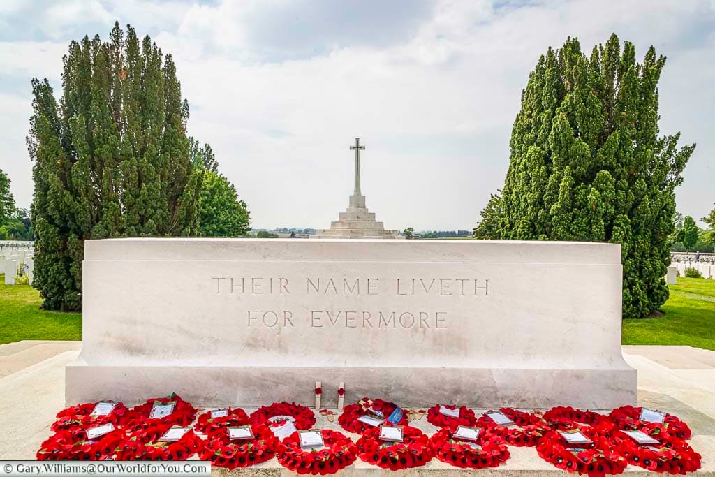 A mass of poppy wreaths in front of the Stone fo Remembrance at Tyne Cott Military Cemetery in Belgium