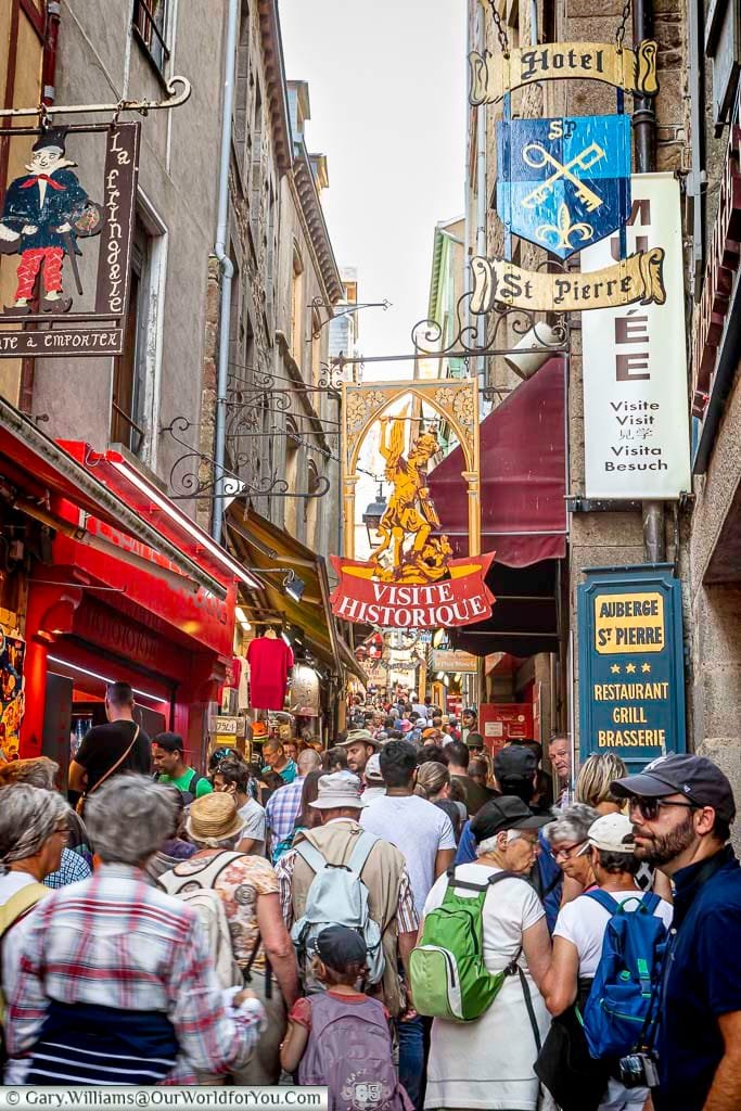 a busy grande rue, discover mont-saint-michel, explore normandy, historic france, iconic normandy, places to visit in france, visit normandy