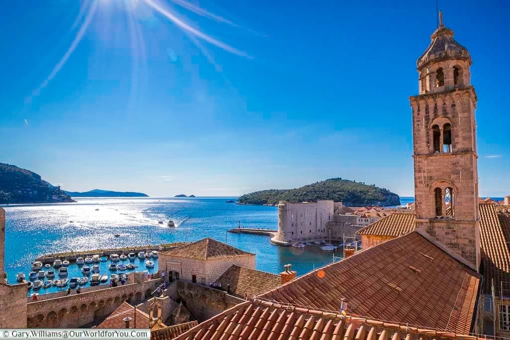A view from the old city walls of Dubrovnik across the Adriatic to the harbour where small boats come and go.