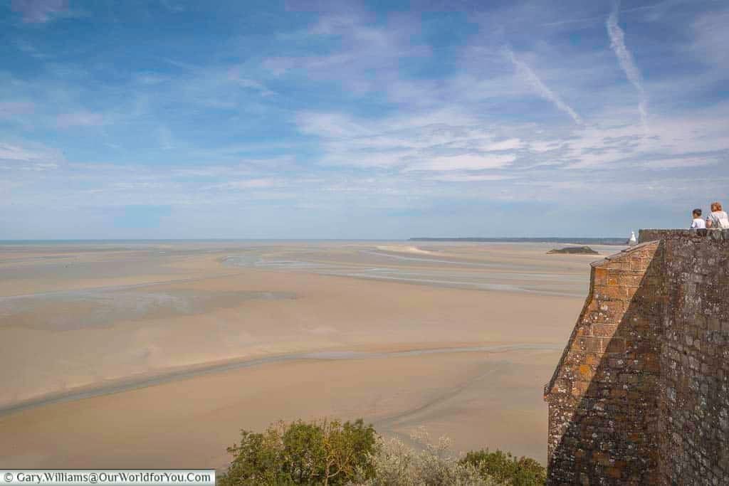 The view of the sand that surrounds Mont-Saint-Michel when the tide is out.