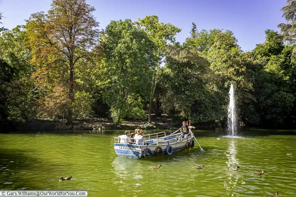A small boat on a lake in front of a fountain in the campo grande park in valladolid in the castile and león region of spain