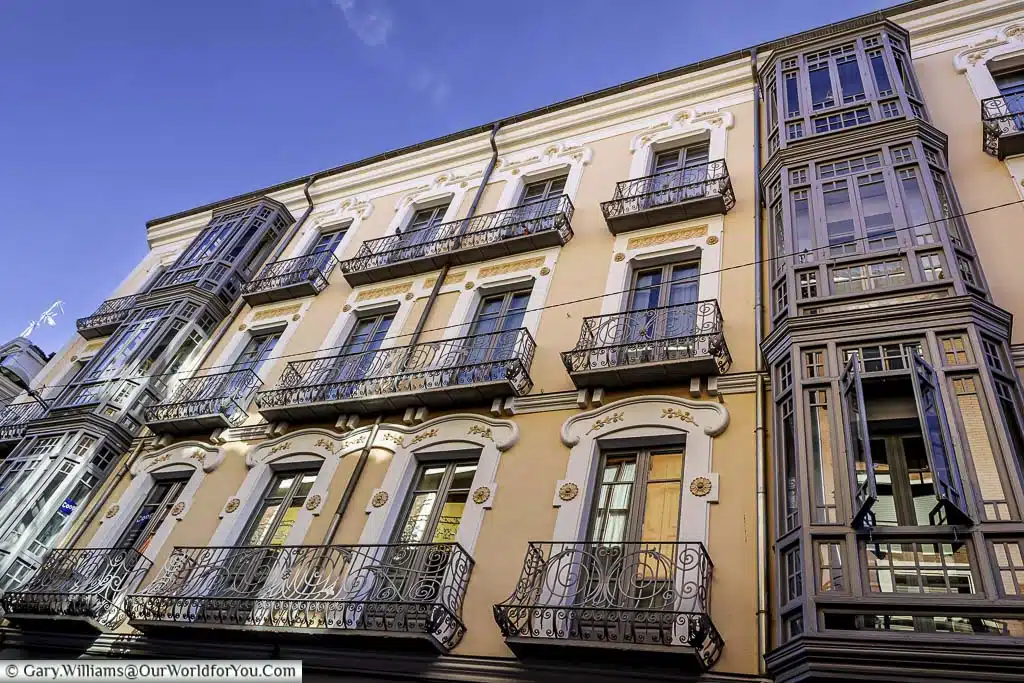 a view up to the ornate windows and balconies on a street in valladolid, spain