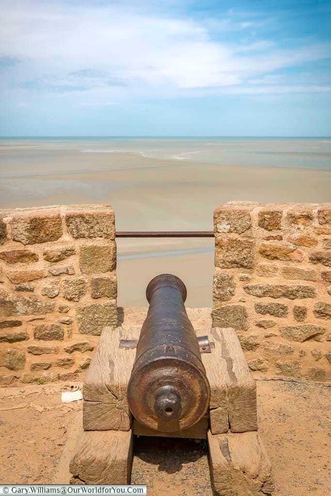 A cast-iron cannon, mounted on a wooden block, as a defensive measure to protect Mont-Saint-Michel