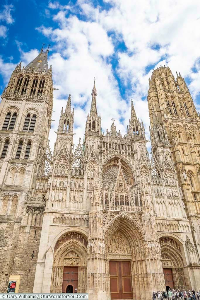 The facade of rouen cathedral, with its twin stone towers either side of the entrance