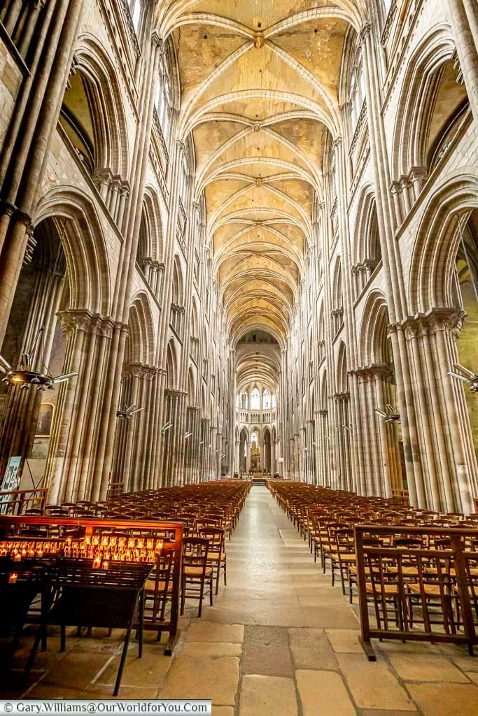 the view along the nave of the cathedral of notre dame in rouen, normandy