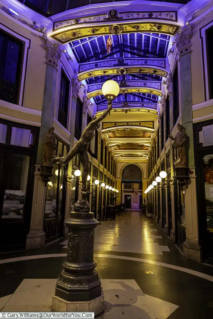 An art deco style statue in the centre of passage gutiérrez at night in valladolid, spain