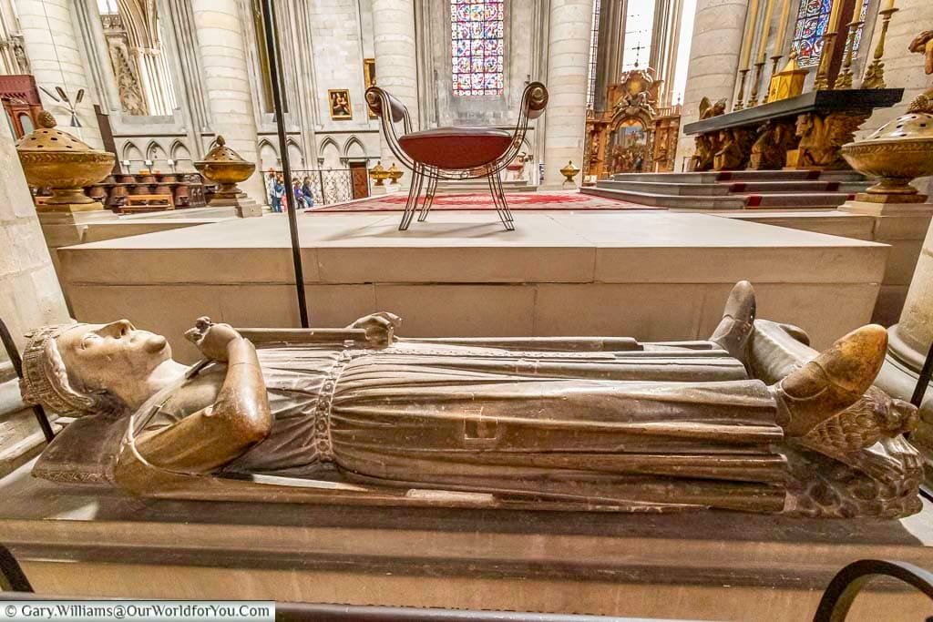The tomb of Richard the Lionheart inside of Rouen Cathedral in Normandy. The stone tomb topped by a supine figure of the King wearing a crown and holding his sword by his side.