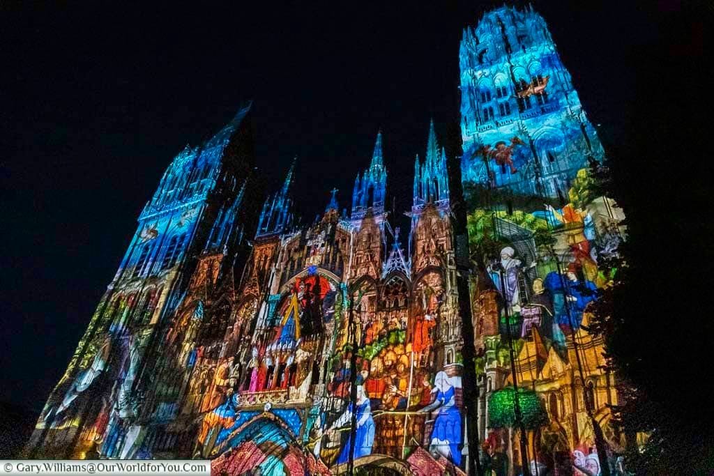 An animated story projected onto the facade of rouen cathedral after dark