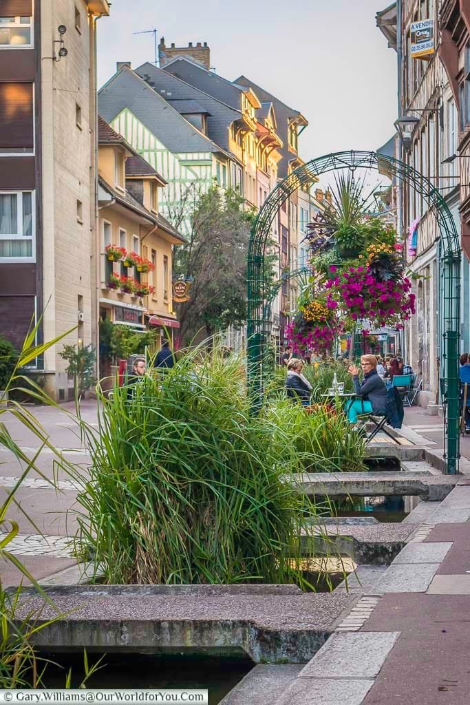 A stream flowing along a restaurant-lined street in Rouen, Normandy