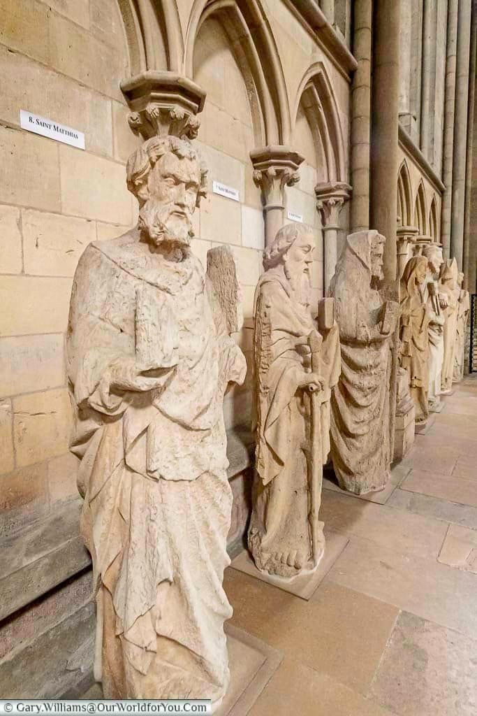 Stone statues of religious figures lined up on the inside of Rouen Cathedral in the heart of Normandy.