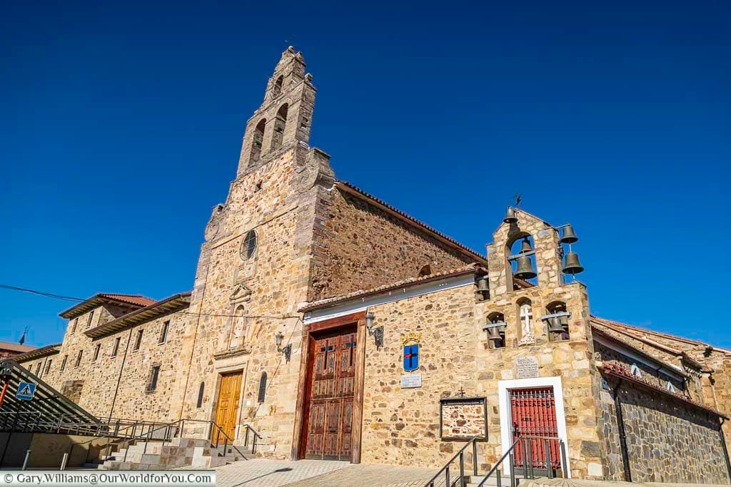 the historic stone church of capilla de la santa veracruz with its iron bells on dsiplay in astorga in northern spain