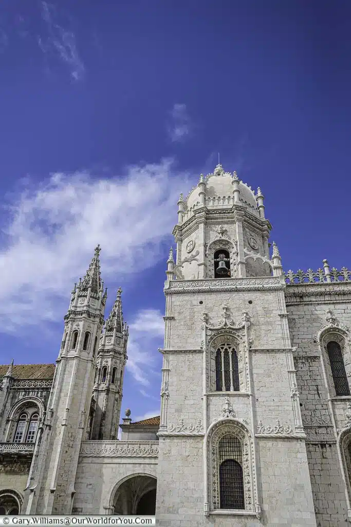 A closeup look of the white stone domed tower of the Mosteiro dos Jerónimos in the Belém region of Lisbon, Portugal