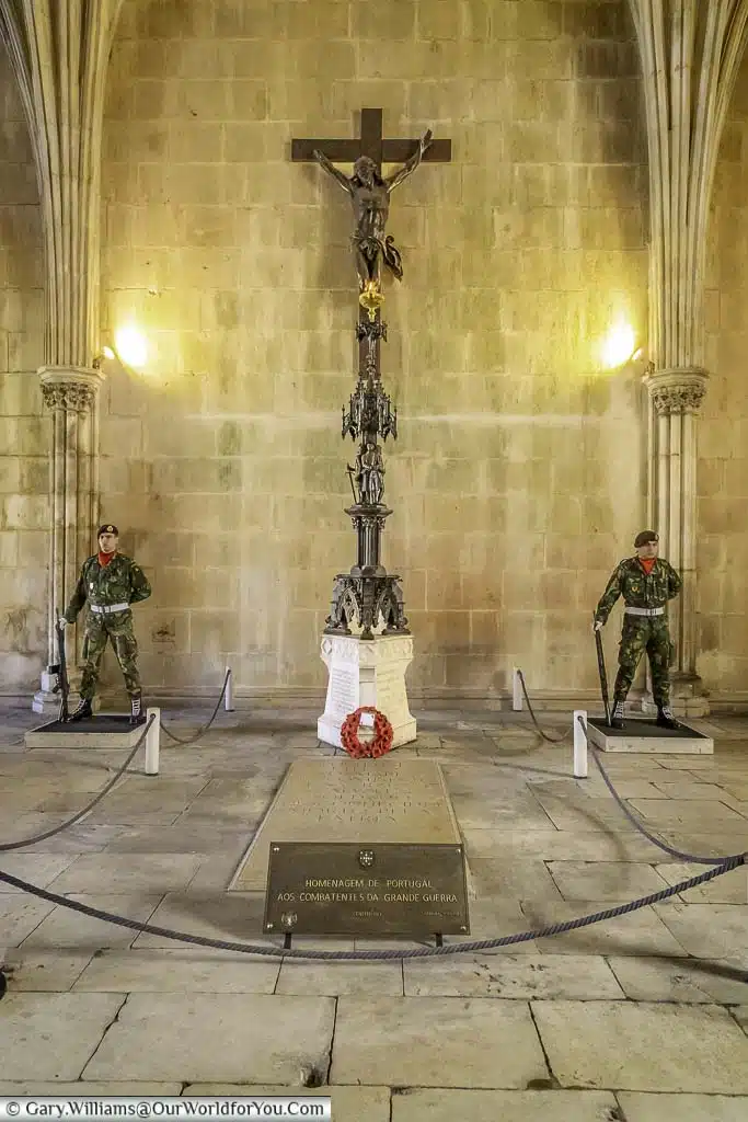 two soldiers standing guard at the tomb of the unknown soldier in the monastery of batalha, portugal