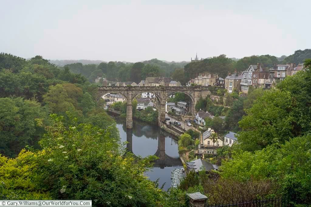 A breathtaking view of Knaresborough Viaduct spanning the River Nidd, surrounded by historic buildings and lush greenery in North Yorkshire. This iconic riverside town offers scenic walks, charming architecture, and a quintessential English countryside experience.