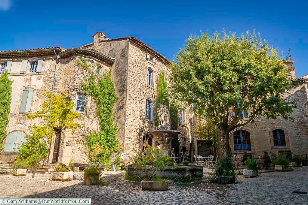 Place de la Fontaine in Provence offers a charming stone-paved square with a historic fountain, surrounded by ivy-covered buildings and leafy trees. This peaceful spot embodies the rustic beauty and timeless atmosphere of southern France’s most picturesque villages.