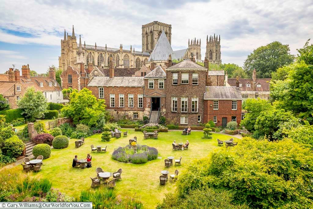 A charming garden view from York’s historic city walls with York Minster towering in the background, showcasing one of the best places to visit in York. This scenic spot highlights the city’s medieval architecture and peaceful green spaces.