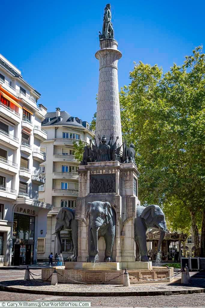 La Fontaine des Éléphants in Chambéry, France, features four majestic stone elephants beneath a towering column honouring General de Boigne. A must-see historic landmark, it stands proudly in the heart of the Savoy region.