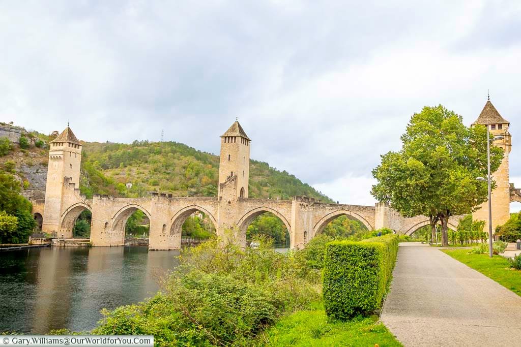 The medieval Pont Valentré bridge spans the Lot River in Cahors, France, with its iconic towers and dramatic Gothic arches. This historic 14th-century structure is one of the most photographed bridges in France and a highlight of any visit to Cahors.