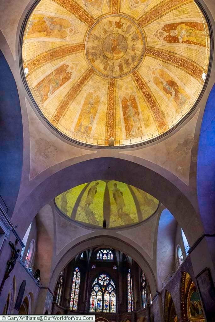 Golden domes and stained glass inside the Cathédrale Saint-Étienne de Cahors, capturing centuries of religious art and architecture. This Romanesque cathedral in southwest France is a hidden gem rich in frescoes, sacred art, and serene ambience.