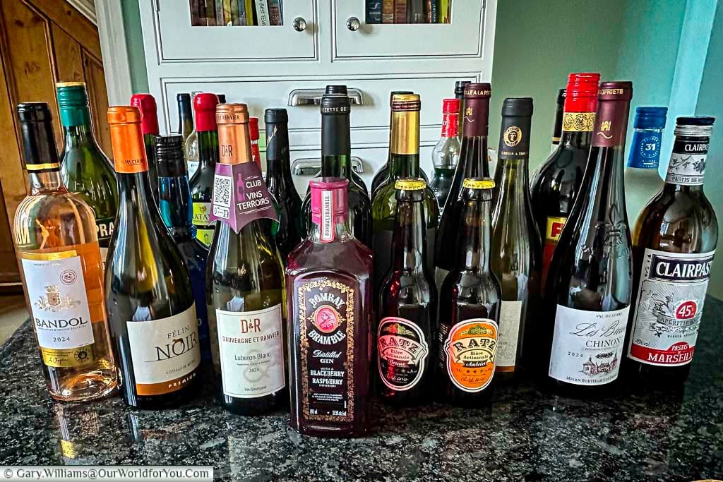 A colourful selection of French wines, craft beers, and spirits brought home from a road trip through France. This image showcases regional flavours from Luberon, Bandol, Chinon, and more – perfect inspiration for wine lovers touring France.