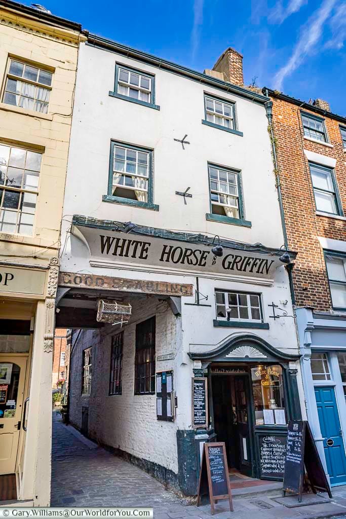 The historic White Horse & Griffin inn stands proudly on Whitby’s Church Street, with chalkboards inviting visitors to its cosy interior. This 17th-century coaching inn is one of the town’s most characterful eateries.