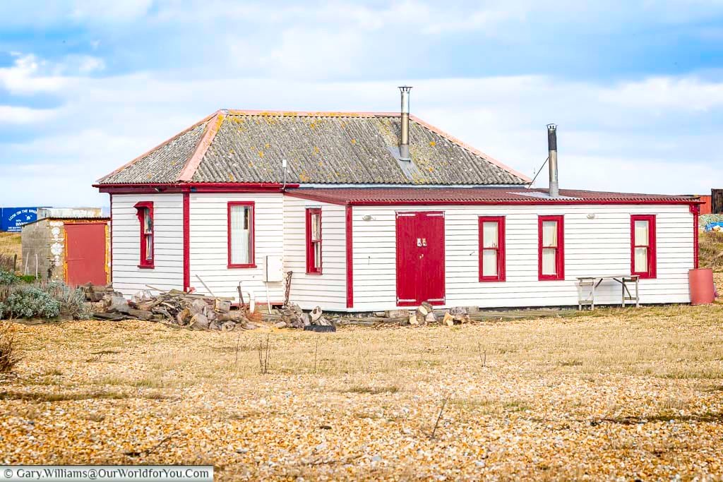 This striking red and white building is the former lifeboat house in Dungeness, standing resilient on the shingle shores of Kent. It’s a nod to the region’s maritime past and a popular landmark on coastal walks.