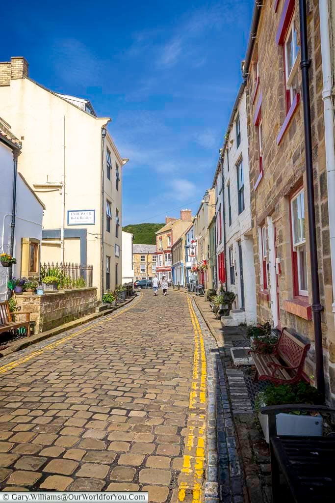 Staithes High Street showcases a picturesque mix of historic cottages and guesthouses along its cobbled lane. This vibrant village heart invites visitors to explore its coastal charm and local hospitality.