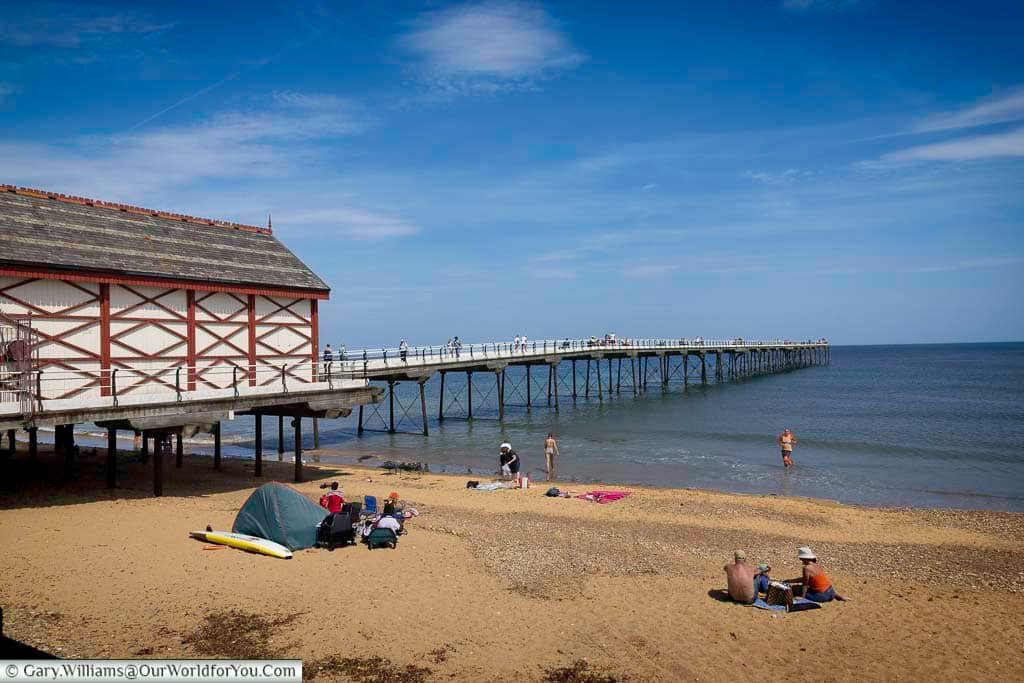Families enjoy a sunny day on the sandy beach next to Saltburn’s historic Victorian pier, stretching out into the calm waters of the North Sea. This charming seaside town on the Yorkshire coast is a hidden gem for beach lovers and history enthusiasts alike.