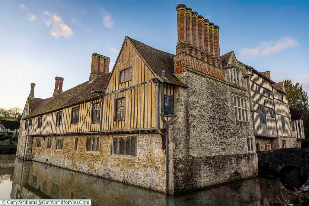 The half-timbered medieval manor of Ightham Mote is reflected in its surrounding moat in rural Kent. This iconic National Trust property is one of England’s best-preserved moated houses.