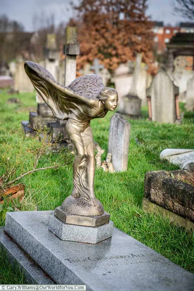 The grave of Thea Canonero Altieri at Kensal Green Cemetery, decorated with a winged lady, similar to the spirit of ecstasy bonnet ornament on a Rolls-Royce car.