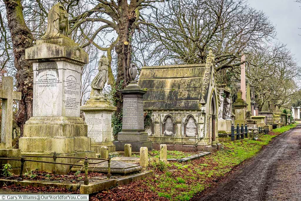 A series of historic tombs and headstones line the path to the chapel at the centre of Kensal Green Cemetery