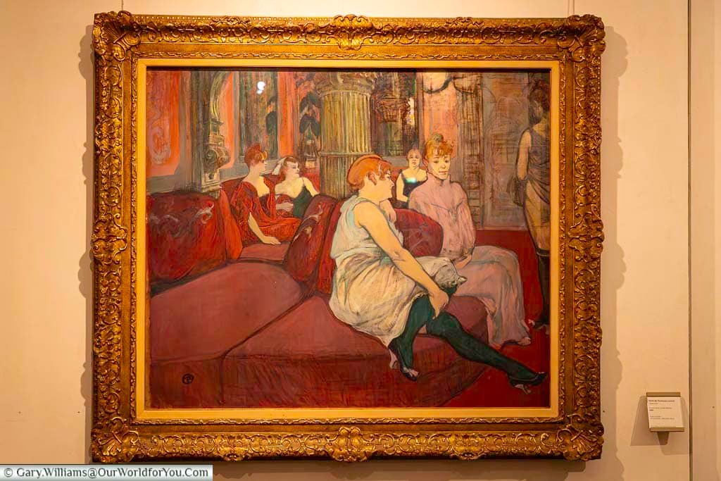 “Salon de la Rue des Moulins” painting by Henri de Toulouse-Lautrec displayed inside the Toulouse-Lautrec Museum in Albi. The artwork reflects the artist’s expressive style and makes the museum one of the top cultural attractions in Occitania.