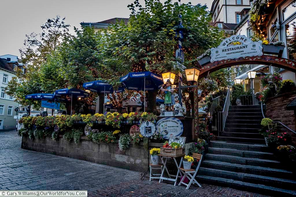 The Löwenbräu Restaurant in Baden-Baden offers traditional German dining beneath leafy terraces and glowing lanterns. It’s a popular place to experience local cuisine while exploring the town’s historic centre.