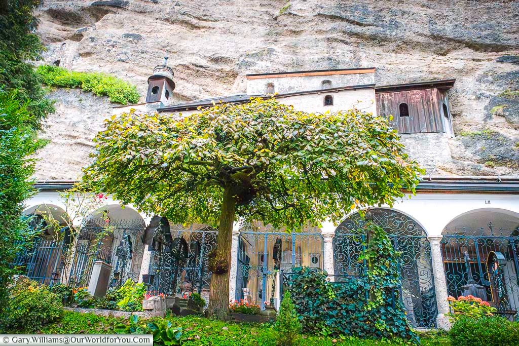 Family crypts below the rockface in the St Sebastian's Cemetery in Salzburg, Austria