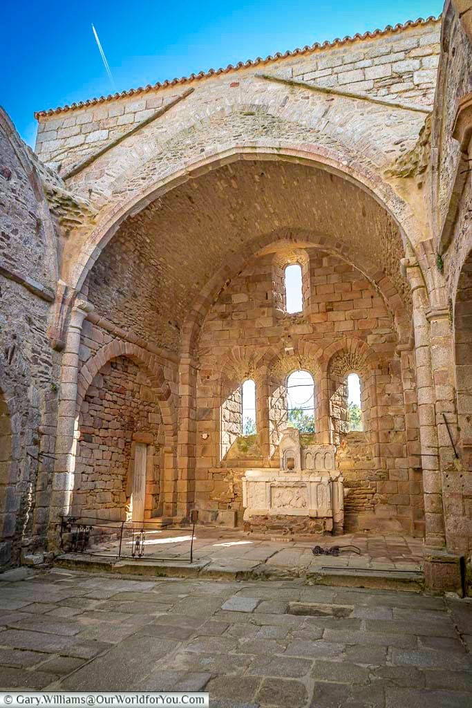 Inside the ruined Old Saint-Martin Church in Oradour-sur-Glane, France, sunlight streams through the arched stone windows onto the preserved altar. This haunting World War II memorial site stands as a powerful reminder of the village’s tragic destruction in 1944.