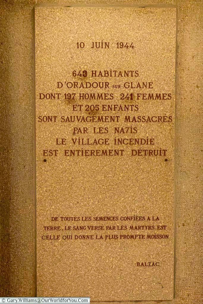 A memorial plaque inside Le Martyrium in Oradour-sur-Glane commemorating the tragic massacre of 10 June 1944. The engraved stone inscription honours the hundreds of men, women and children killed during the Nazi occupation of France.